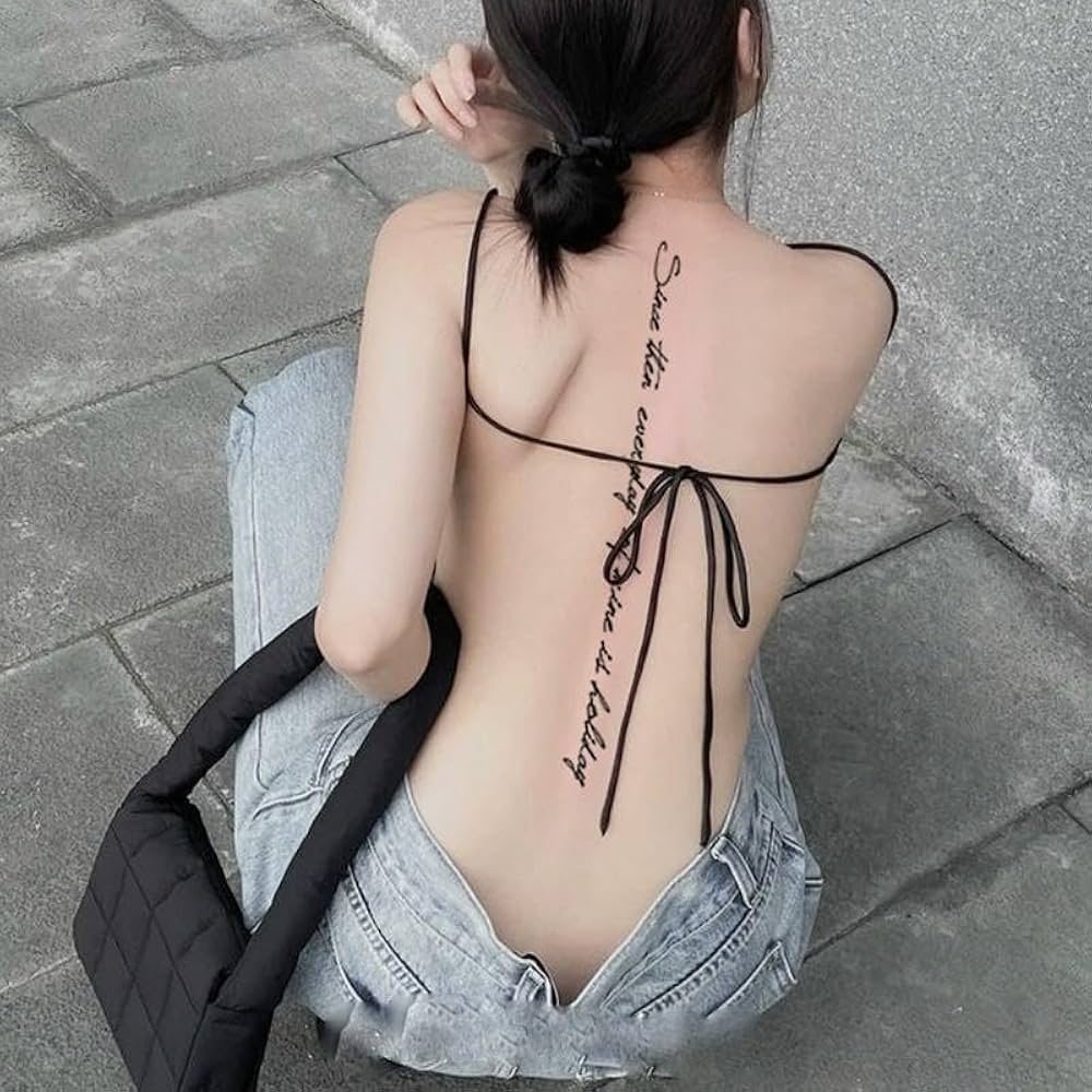 Tatouage calligraphique et épuré sur la colonne vertébrale