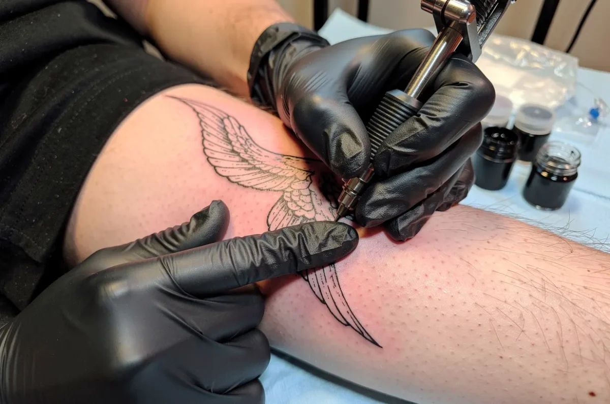 Séance de tatouage fine line sur un avant-bras